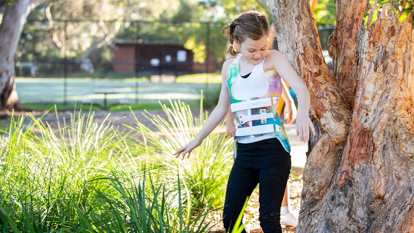 A young girl with the SoliBrace walking.